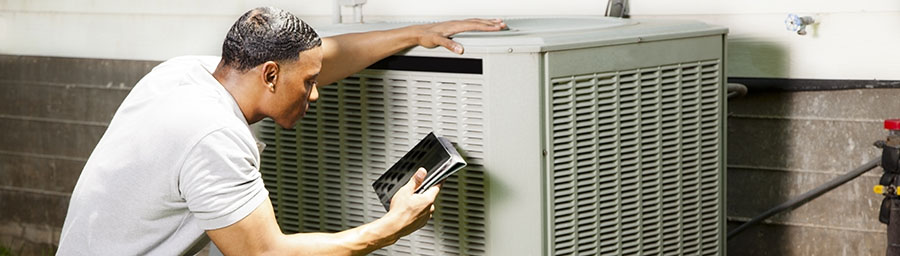 Home inspector, repairman uses digital tablet to check air conditioners.